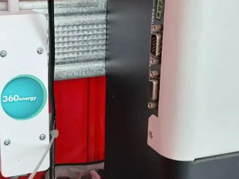 eDAS mounted on a rail under an inverter, in a red cabinet